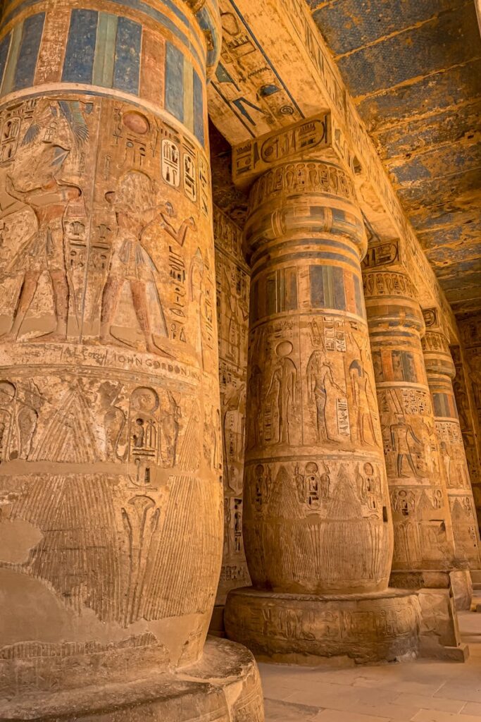 Intricately carved columns in the Luxor Temple, showcasing ancient Egyptian art and architecture.